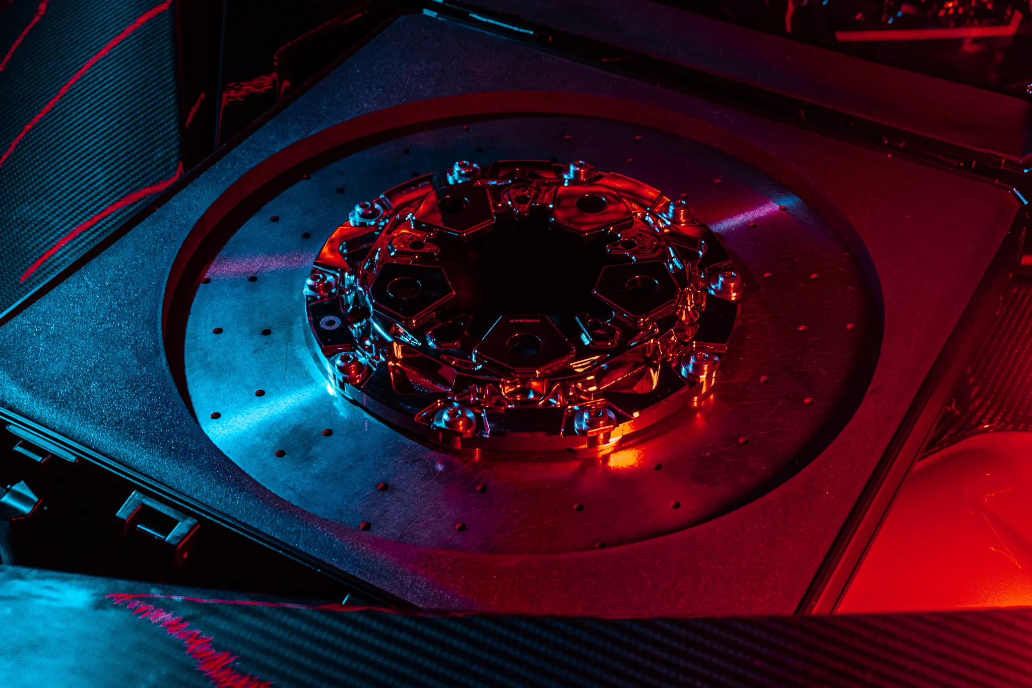 OPUS Carbon Ceramic disc under red lighting